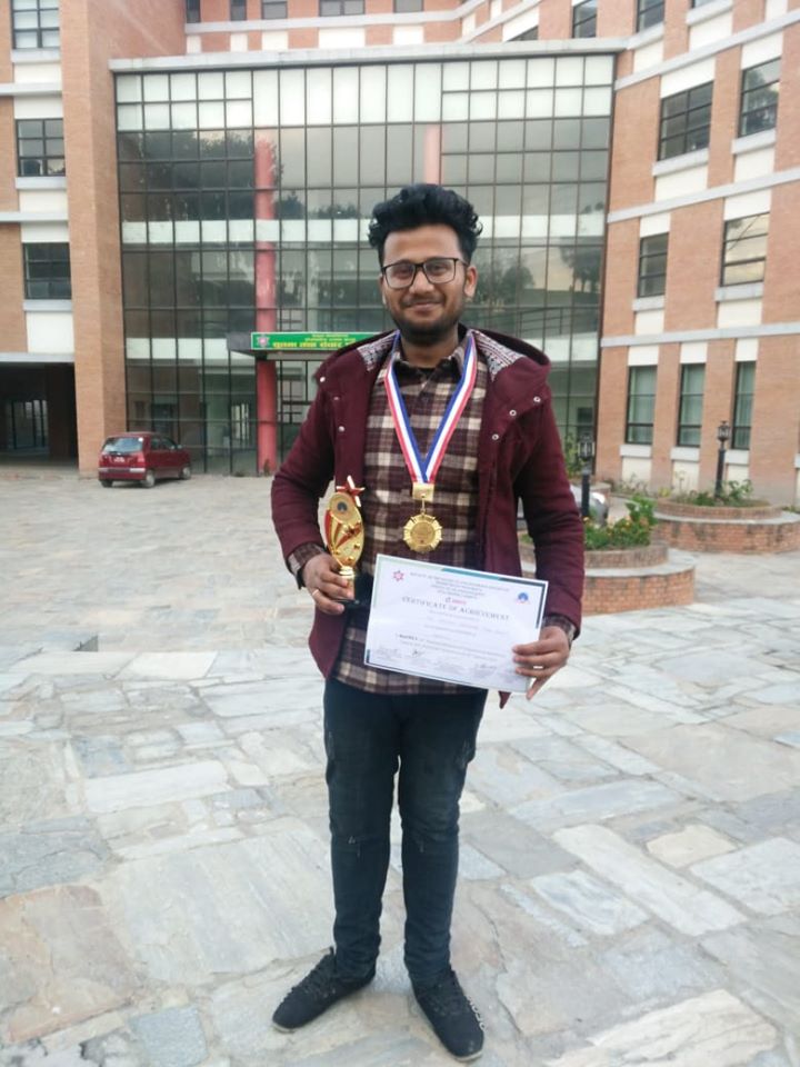 Jay holding a trophy and certificate of achievement at Mechtrix competition